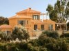 The rear of the villa surrounded by greenery 